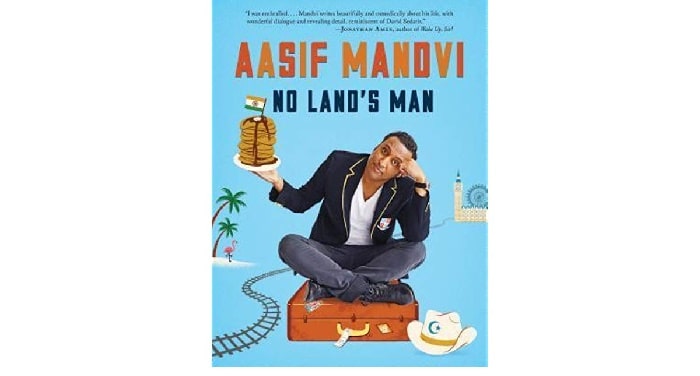Aasif Mandvi sitting on a suitcase while holding a pancake in a plate with indian flag on the top of his blue covered book No land's Man 